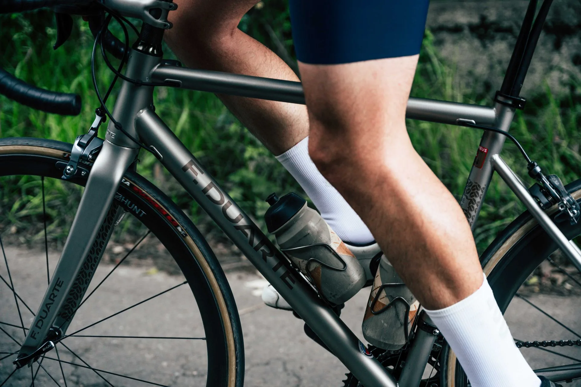 A bicycle with only the rider's legs visible