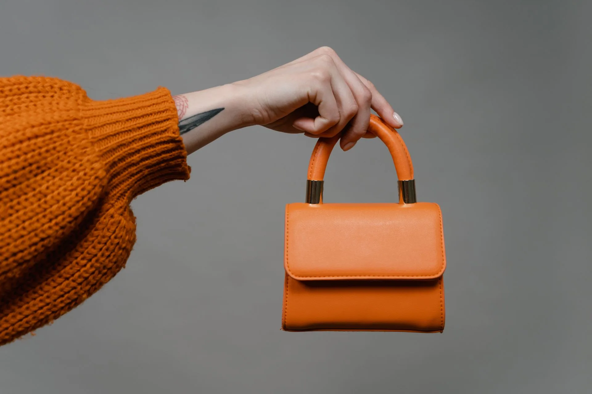 An orange bag held by hand