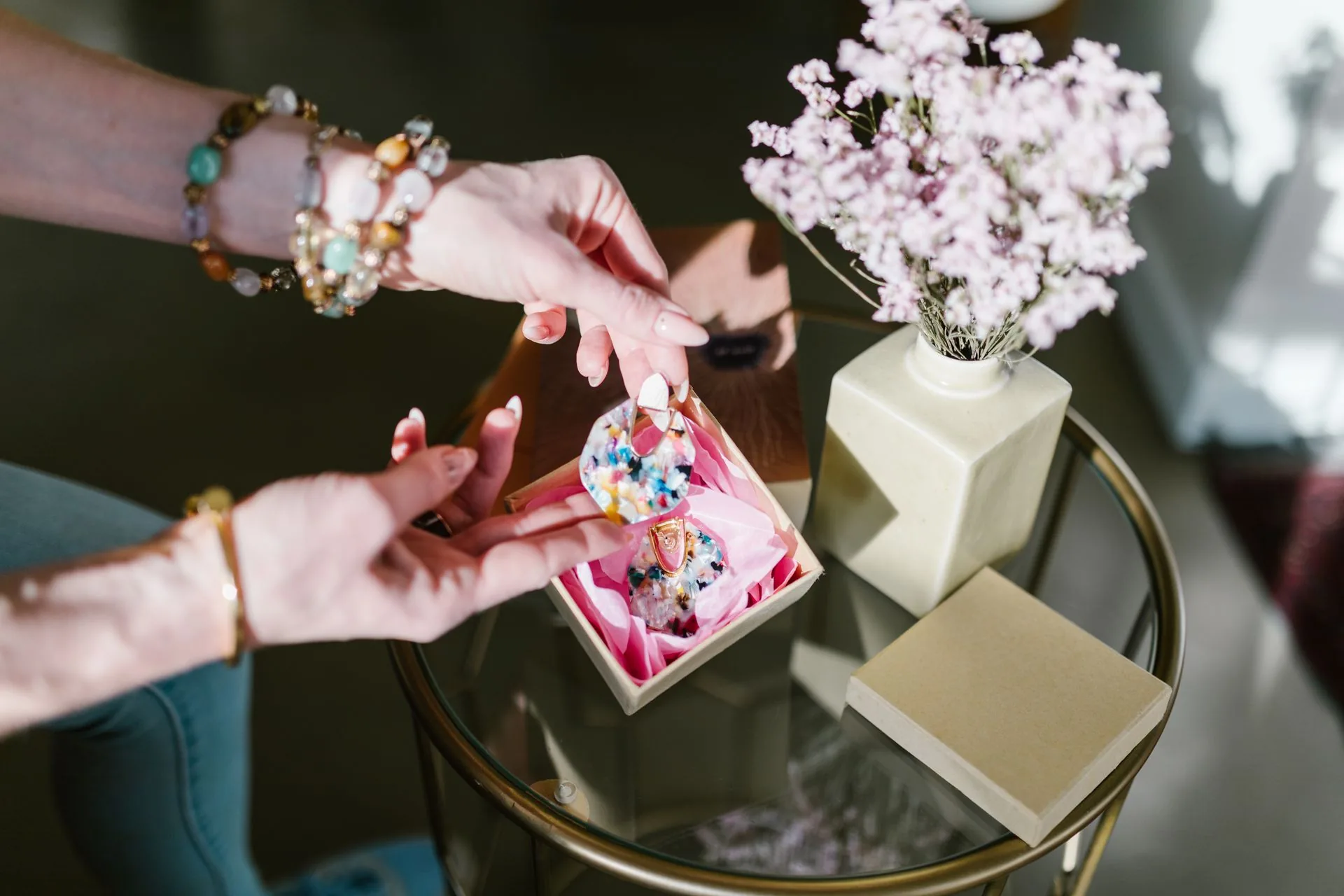 Colorful earrings in a box opened by hand