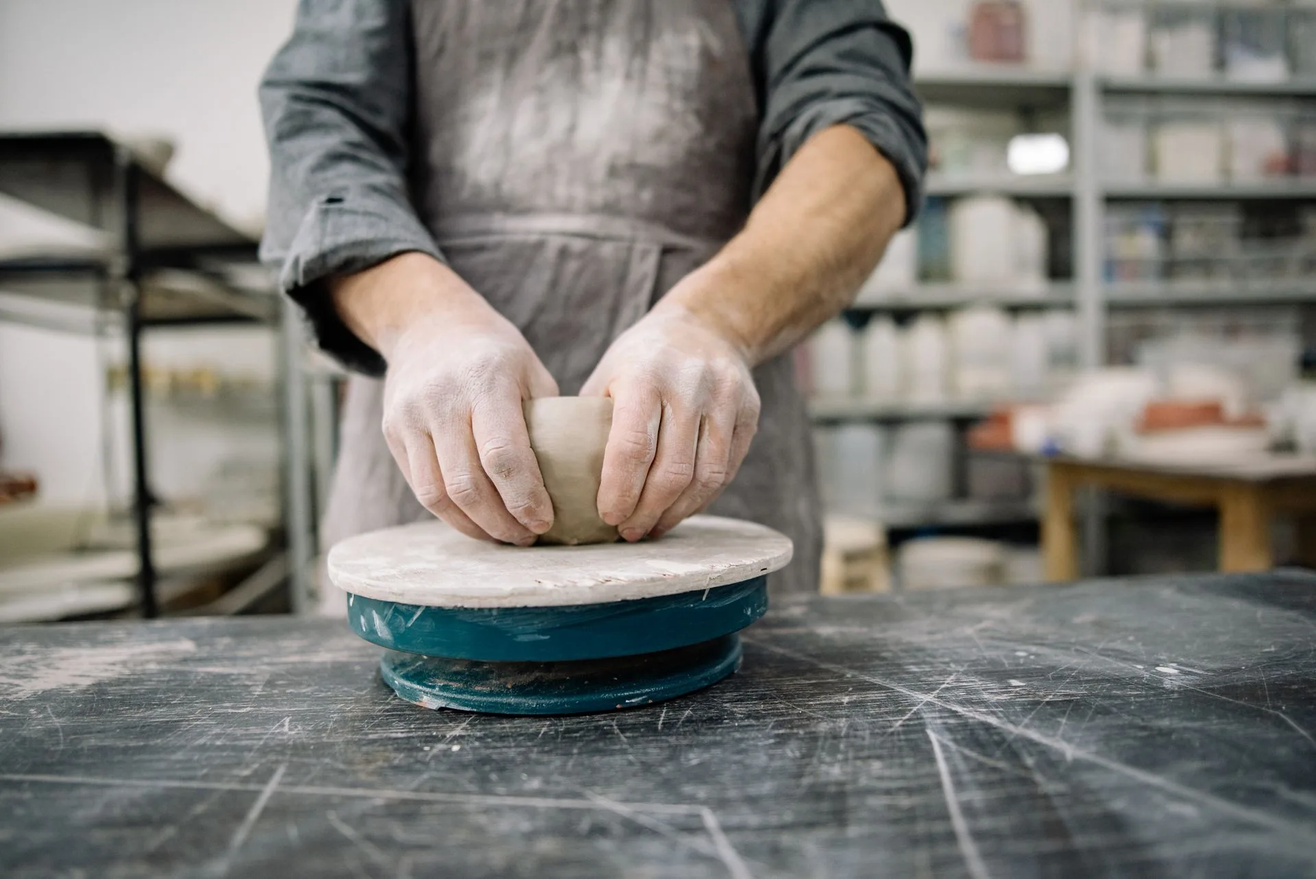 Hands shaping a ceramic piece